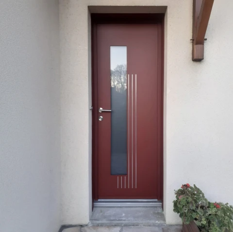 Entrée extérieure d'une maison contemporaine avec porte d'entrée moderne en bois rouge bordeaux